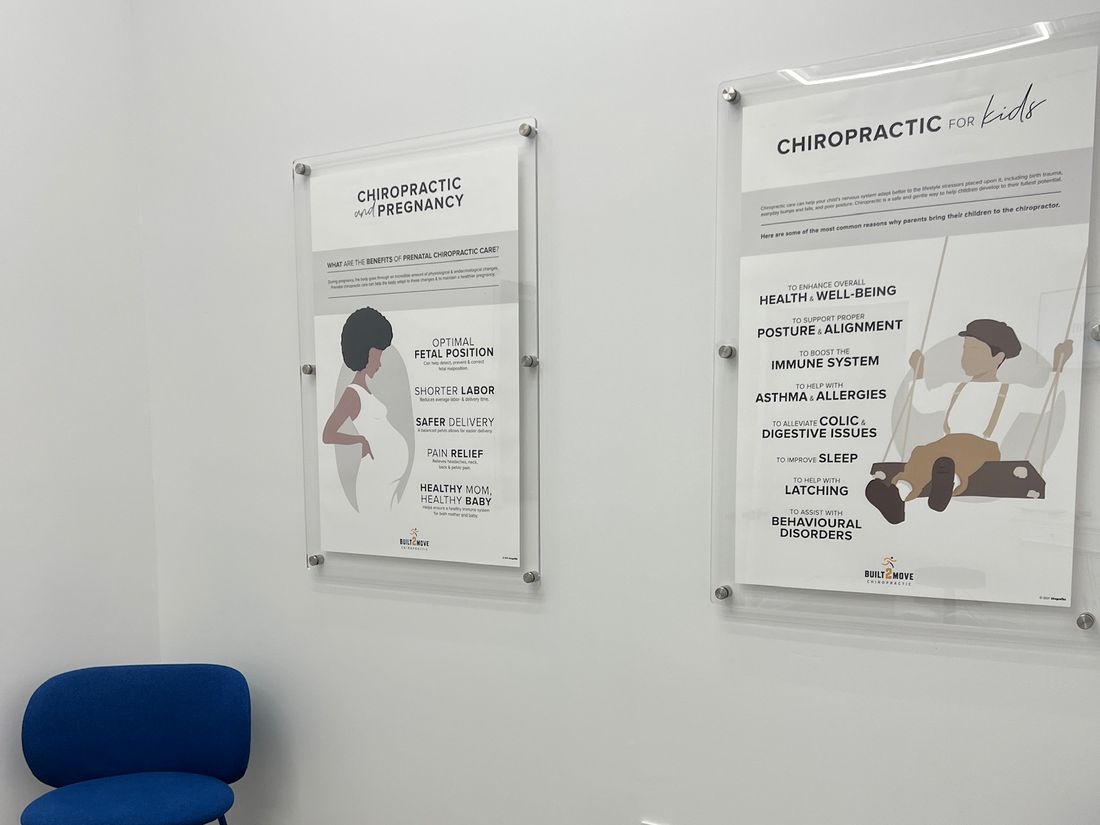 Built 2 Move exam room wall with pregnancy and pediatric chiropractic posters