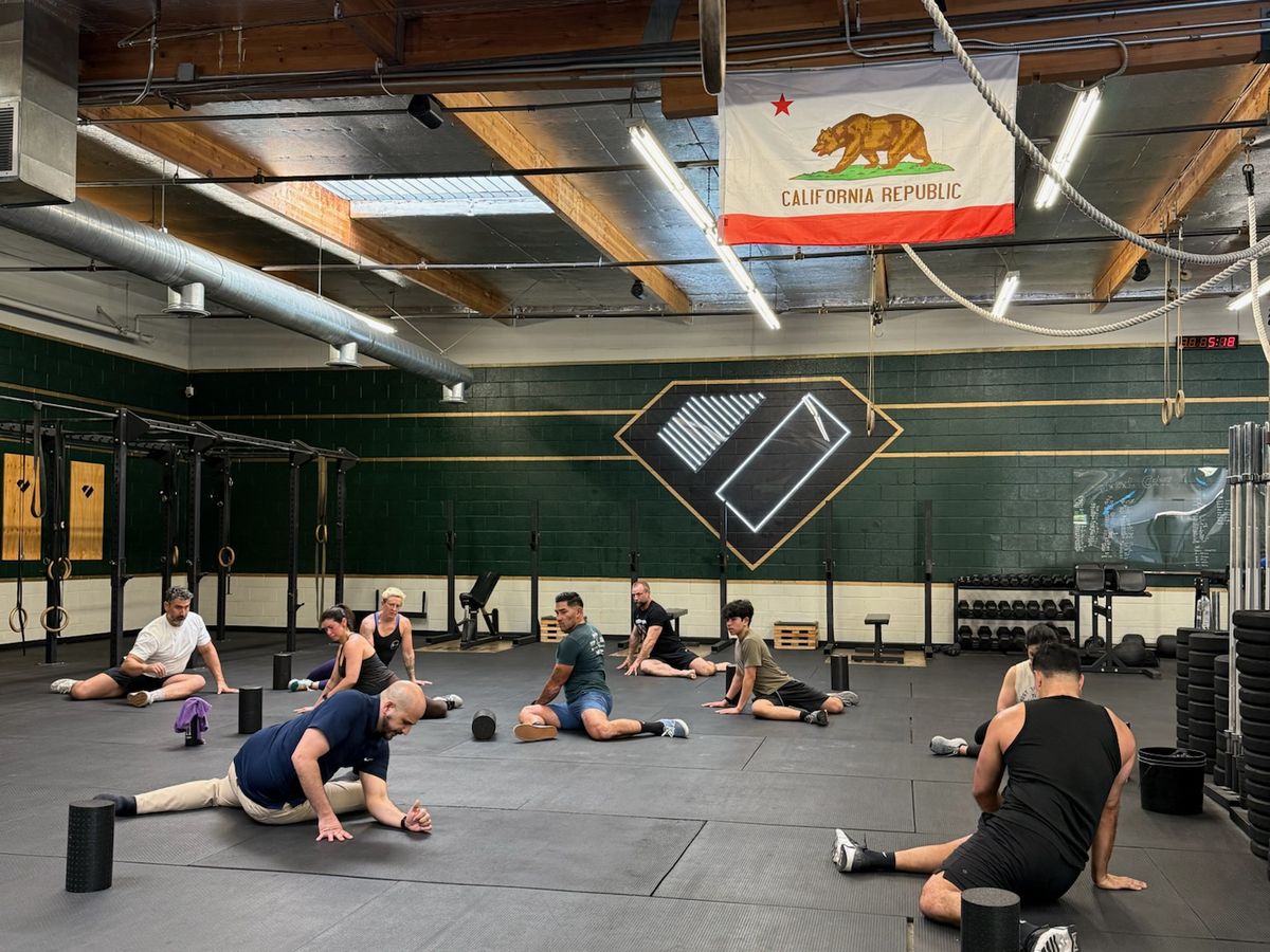 Built 2 Move workshop in a gym, group doing floor mobility